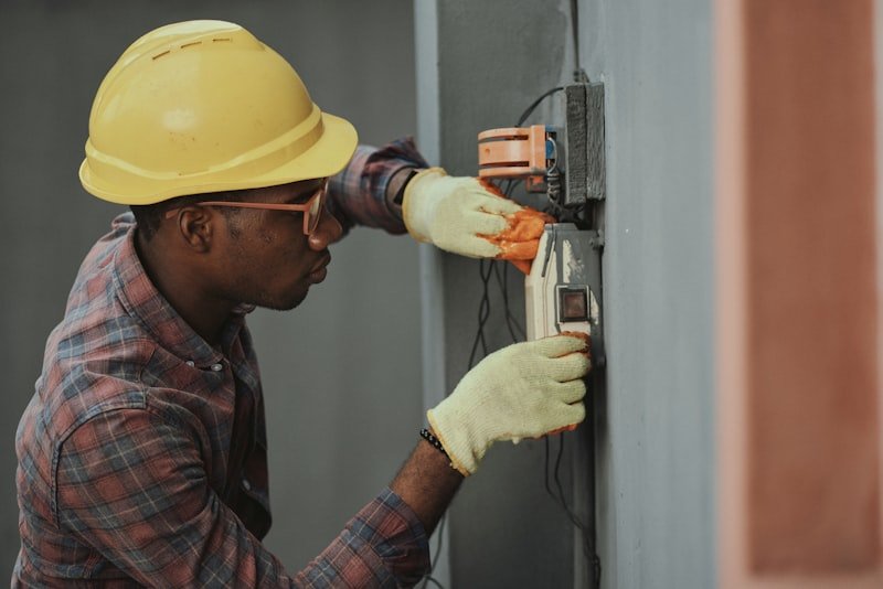 Artisan intervenant sur un tableau électrique lors d’une rénovation